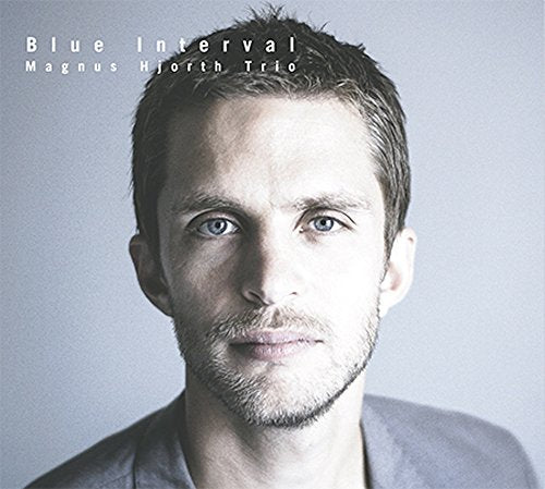CD cover: Portrait of a man with short hair and blue eyes.