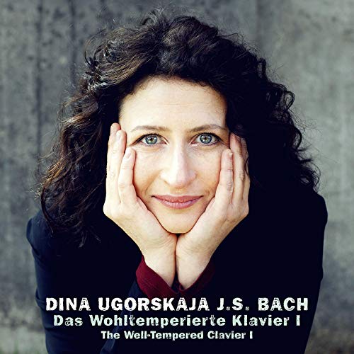 "Woman with curly hair resting face on hands, album cover with white text."