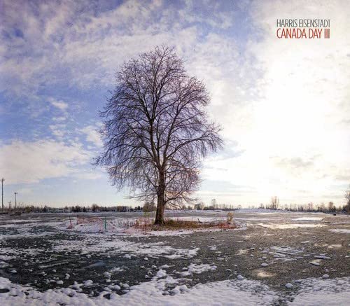 CD cover featuring a leafless tree in a snowy field under a cloudy sky.