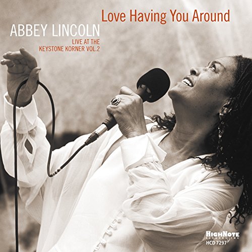 "Album cover featuring Abbey Lincoln singing into a microphone, sepia-toned with orange text."