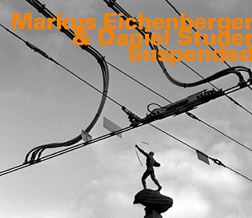 "CD cover with black and white image of a statue and orange text."