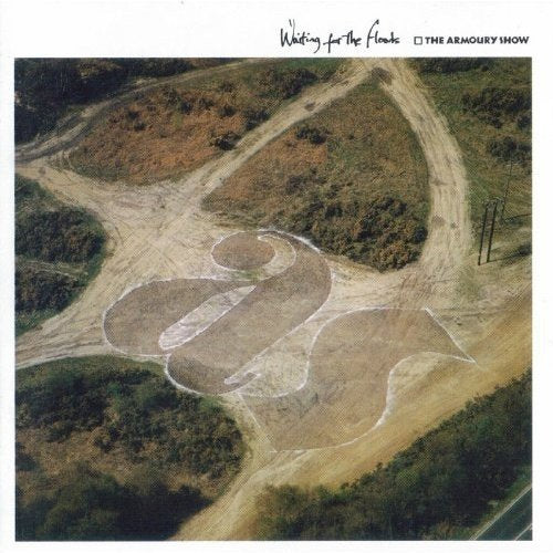 "Album cover with aerial view of a field with a large 'S' design."