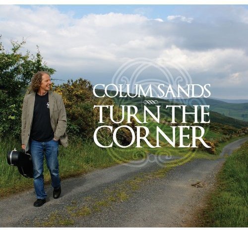 Man walking on a winding country road, carrying a guitar case, with album title overlay.