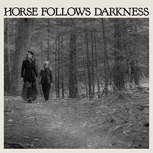 CD cover: Two figures walk away into a dark, dense forest.