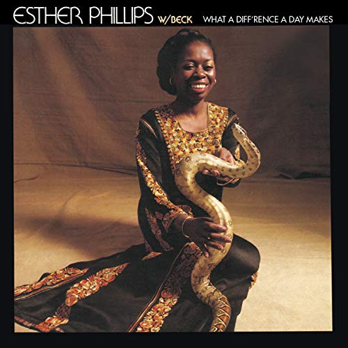 The image depicts a woman holding a snake, with the title "What A Diff'rence A Day Makes" and the artist's name "Esther Phillips" displayed prominently. The alt text for this image could be: "Album cover featuring Esther Phillips holding a snake, wearing an ornate black dress."