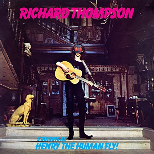 Richard Thompson album cover: man with fly-like goggles playing guitar indoors.