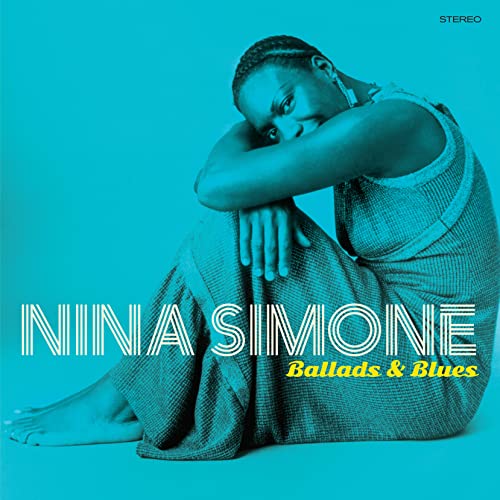 Nina Simone sitting in a textured dress against a bright blue background.