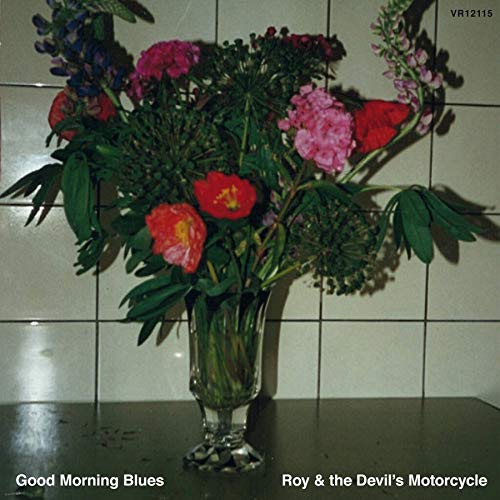 CD cover with a vase of colorful flowers against a tiled wall.