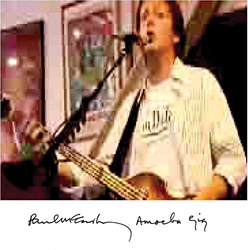 Paul McCartney playing bass guitar at Amoeba Music, pixelated image.