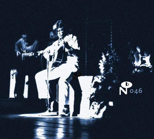 Alfonso Lovo performing with a guitar on stage, vintage photo.