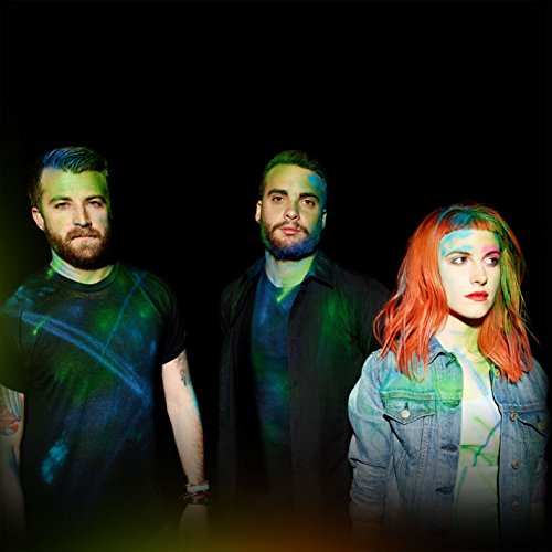 Paramore album cover featuring three band members against a dark background with colorful lighting.