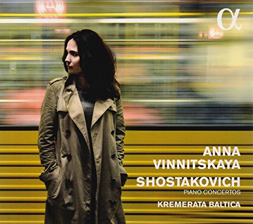 CD cover with a woman in a trench coat and blurred background.
