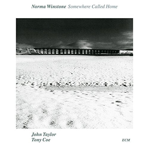 "Album cover with black-and-white photo of a sandy beach and arched bridge."