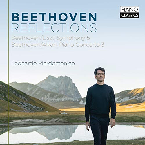 CD cover featuring a man in black standing by a serene mountain lake.