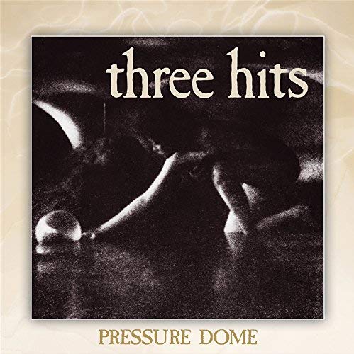 "Sealed CD case with 'three hits' and 'Pressure Dome' text on the cover."