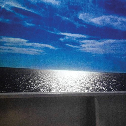 The alt text for the image is: "A CD cover featuring a serene ocean scene with blue sky."