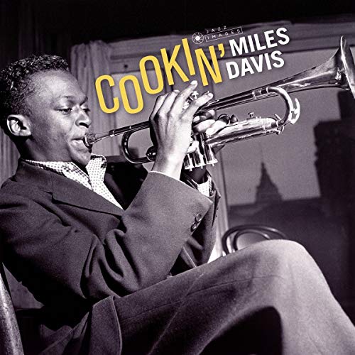 Miles Davis playing trumpet on the album cover “Cookin’”.