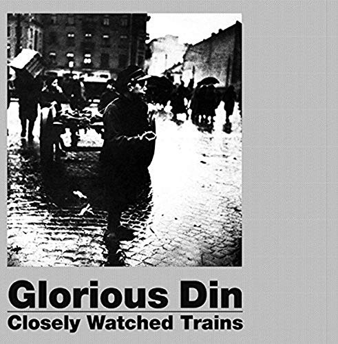 Black and white photo of people on a wet street, album title below.