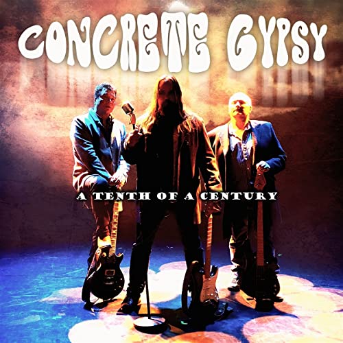 CD cover featuring three men with guitars on a stage.