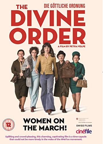 Five women walk together, one holding a sign with a feminist fist symbol.