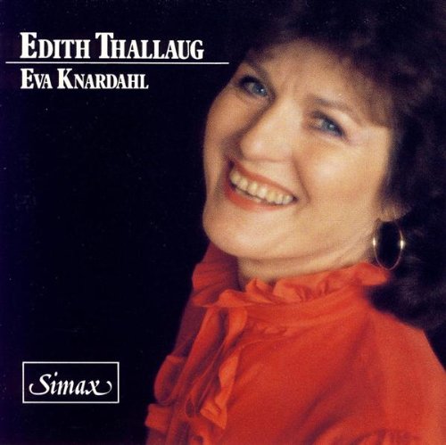 "CD cover with a smiling woman in an orange ruffled top against a black background."