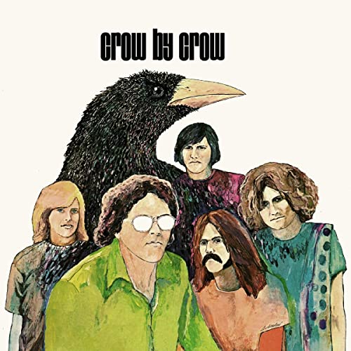 Album cover: a large black crow looms over five people with 1970s hairstyles.