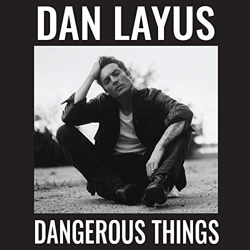 Black-and-white vinyl album cover with a man sitting on the ground, titled "Dangerous Things".