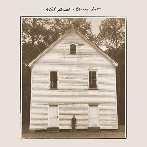 "Album cover featuring sepia-toned image of a man standing in front of a white building."