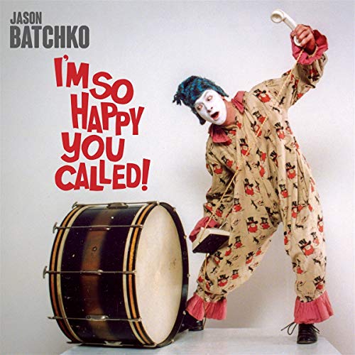 Clown in patterned suit with a drum and telephone receiver.