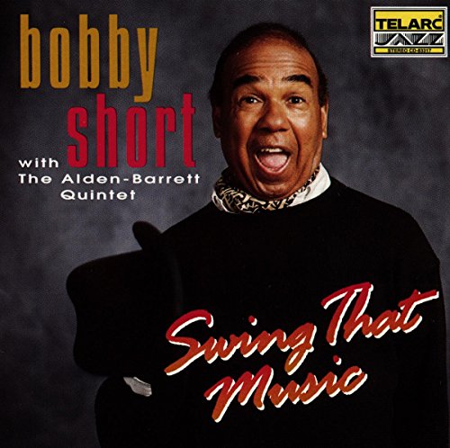 Bobby Short's album cover featuring the artist in a black sweater and holding a hat.