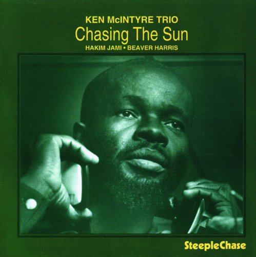 "CD cover with a green-tinted photo of a man holding a saxophone."