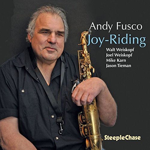 Man holding a saxophone, album cover with title "Joy-Riding" and artist name.