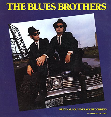 "CD cover featuring two men in black suits sitting on a car hood."