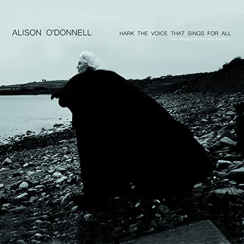 Alison O’Donnell album cover: woman in dark cloak by the sea.
