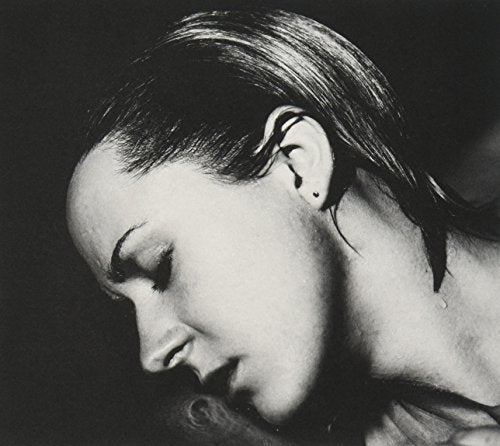 "Black and white CD cover featuring a woman with her head bowed and eyes closed."