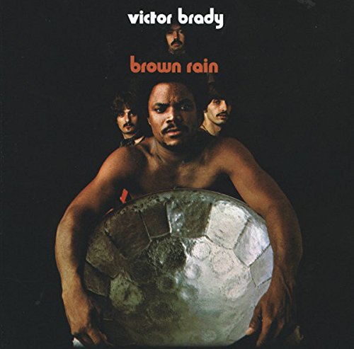 Album cover for Victor Brady’s “Brown Rain” featuring a man holding a sphere.