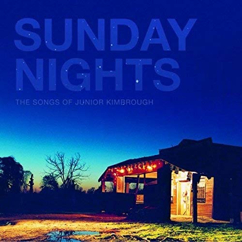 "Vinyl record cover with a lit house at dusk, wrapped in plastic."