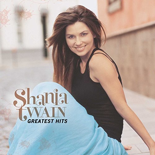 "Shania Twain album cover featuring a smiling woman in a black tank top."
