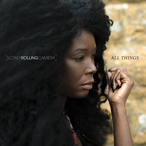 "Album cover featuring a woman with curly hair looking down, holding a lock of hair."