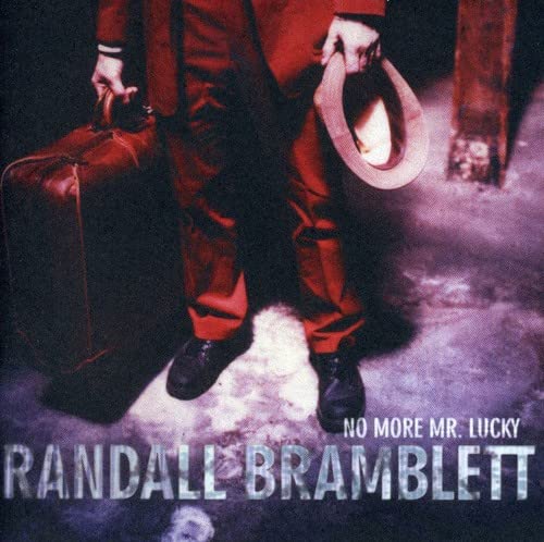 Man with suitcase and hat, album cover for Randall Bramblett.