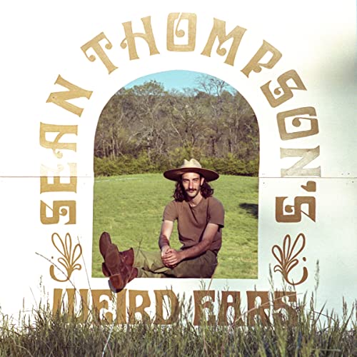 CD cover: Man with hat seated in a field, arched text.