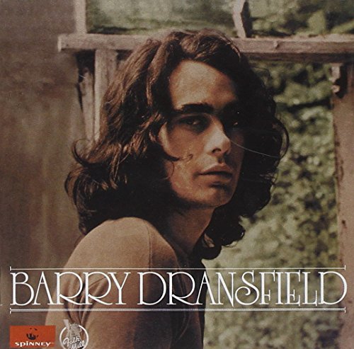 Album cover with a man having long hair, outdoors, with artist's name.