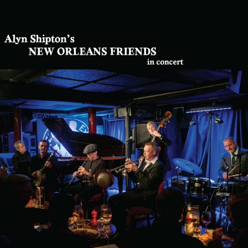 Jazz band performing on stage with instruments, dark club atmosphere.
