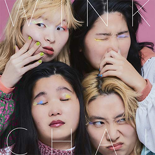 Four young women with colorful makeup and playful expressions.