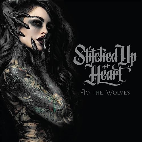 CD cover: woman with dark makeup and tattoos, gothic lettering.