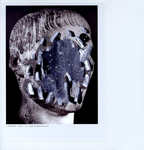 A black-and-white image of a damaged stone head sculpture with metal plates on its face.