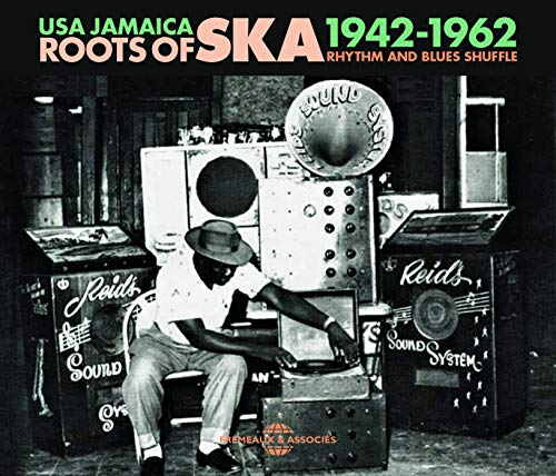 Vintage photo of a man operating a large sound system outdoors.