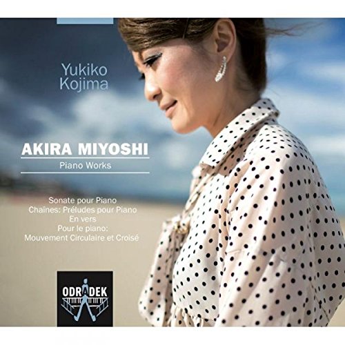"CD cover featuring a woman in a white polka-dot shirt on a beach."