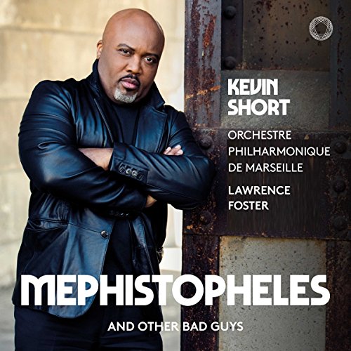 Bald man in black leather jacket standing by metal door on album cover.