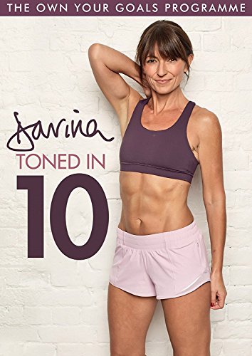The image is a DVD cover for a fitness program. "DVD cover featuring a woman in workout attire against a white brick wall."